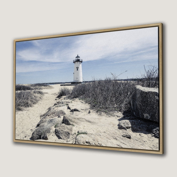 Framed Wall Art featuring a serene lighthouse scene. Coastal landscape art with neutral tones and a touch of blue sky. Perfect for a calming home decor.