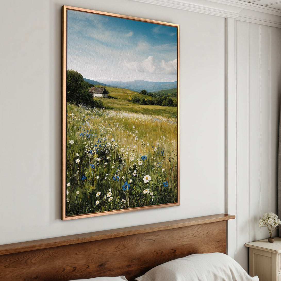 Framed Wall Art: Landscape Canvas Print with wildflowers, cottage, and mountains. Featuring a serene, natural color palette with blues, greens, and yellows.