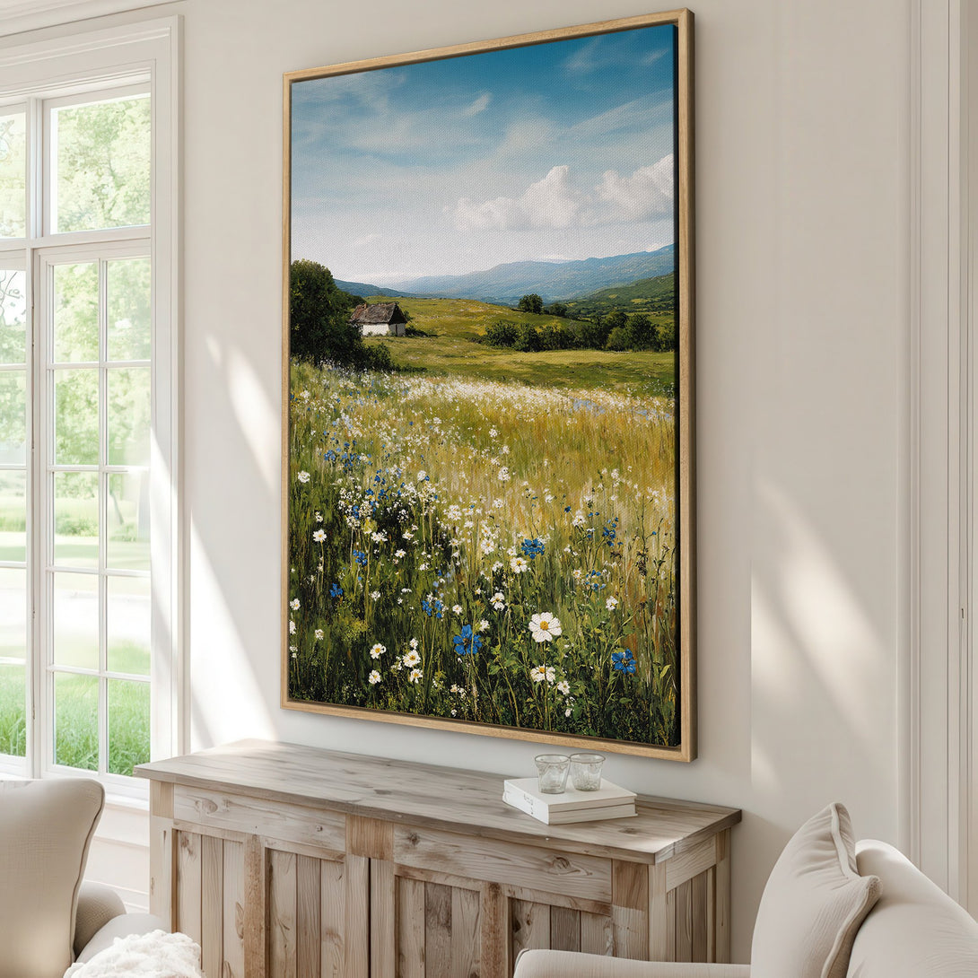 Framed Wall Art of a serene landscape with a field of wildflowers, blue sky, and a cabin. Earthy tones with pops of blue and white. Perfect for home decor!