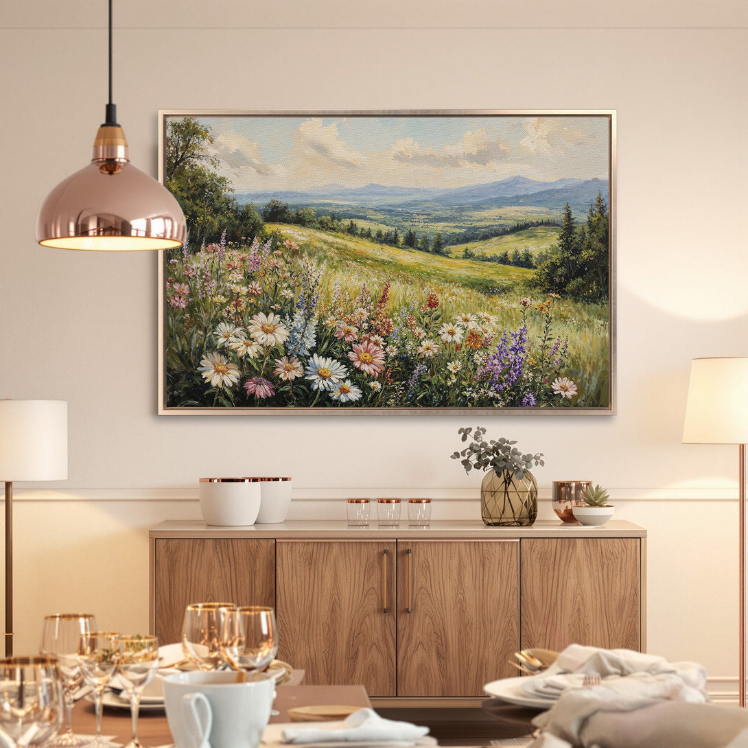 Framed Wall Art: Landscape painting of a vibrant wildflower meadow in a warm, inviting interior. Earthy tones and calming blues create a serene atmosphere.