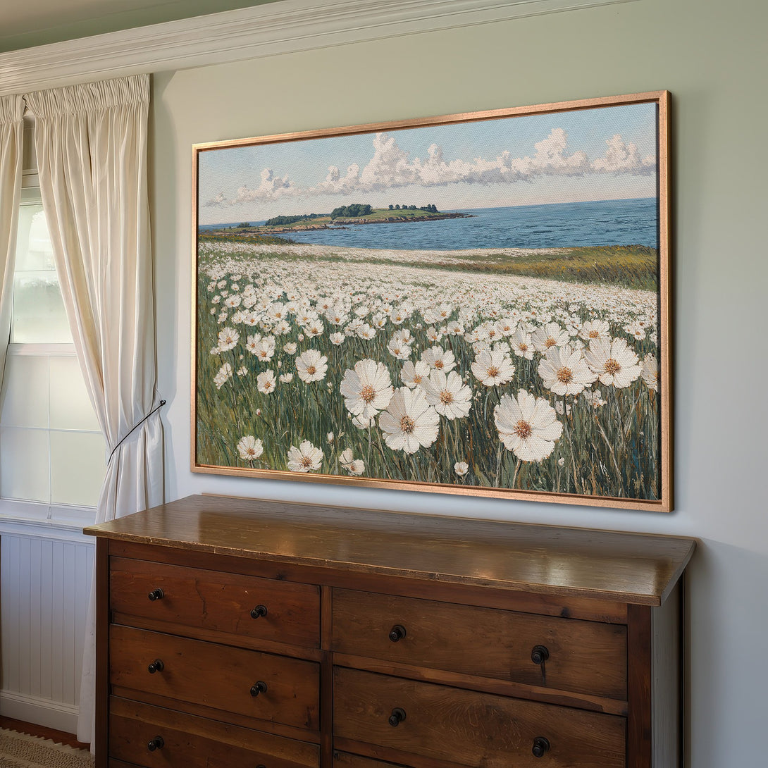 Framed Wall Art: Coastal landscape Canvas Print with white flowers, blue skies, & green grass. Adds serene, natural beauty to any room.