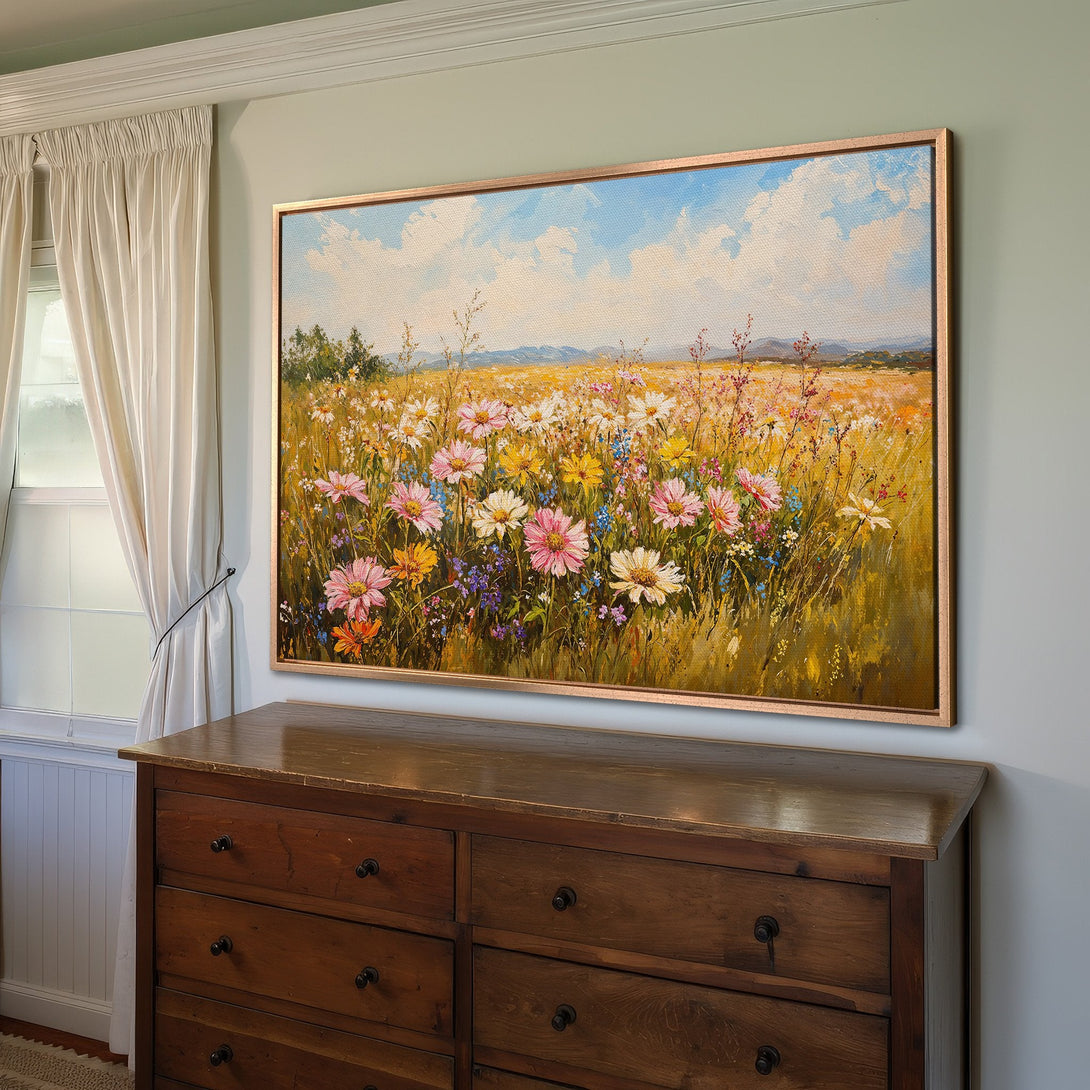 Framed Wall Art: Impressionistic wildflower canvas print in a warm, inviting interior. Featuring a vibrant color palette of pinks, yellows, and blues.