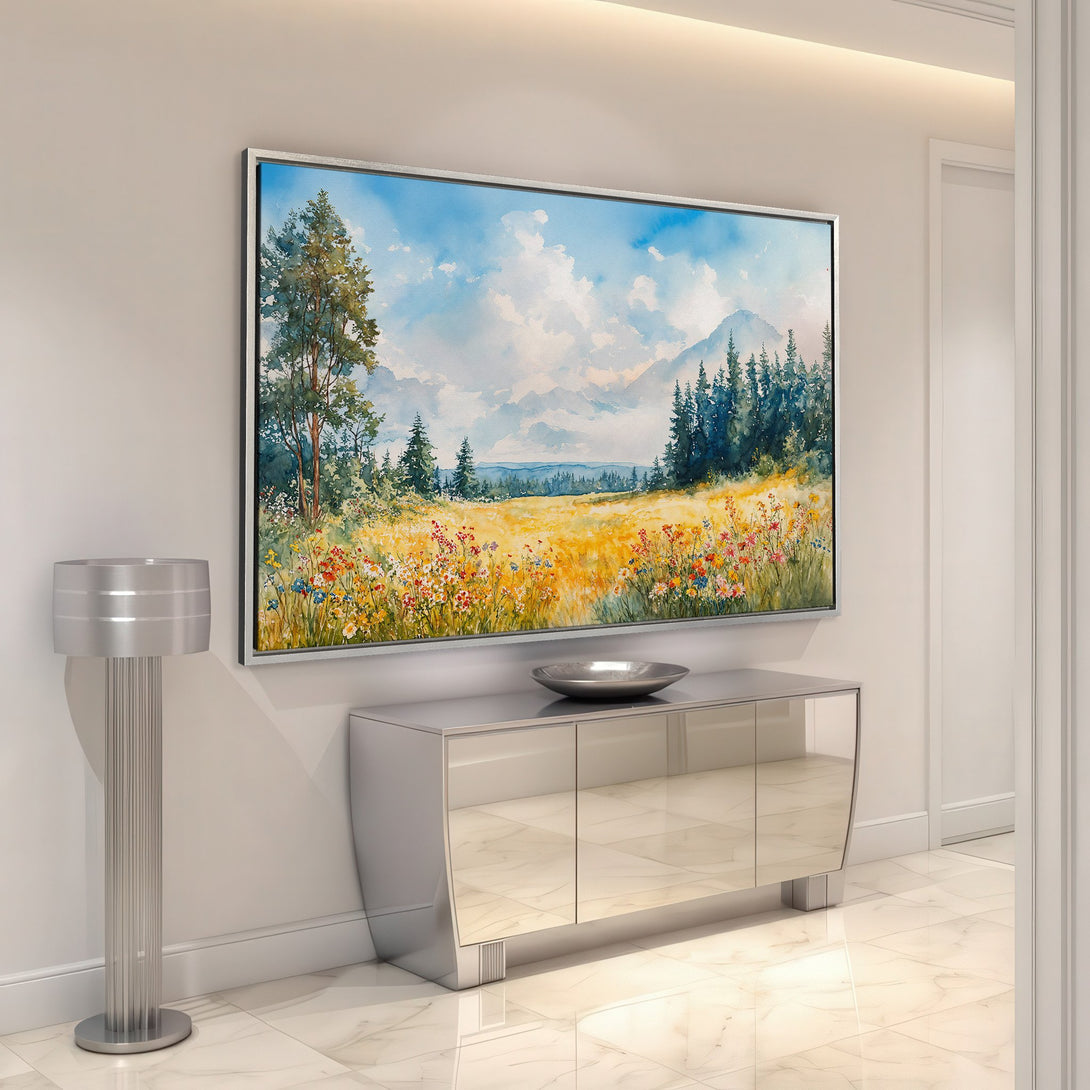 Framed Wall Art: Watercolor landscape Canvas Print with vibrant wildflowers, blue sky, and mountain backdrop. Adds a touch of nature to your home decor.