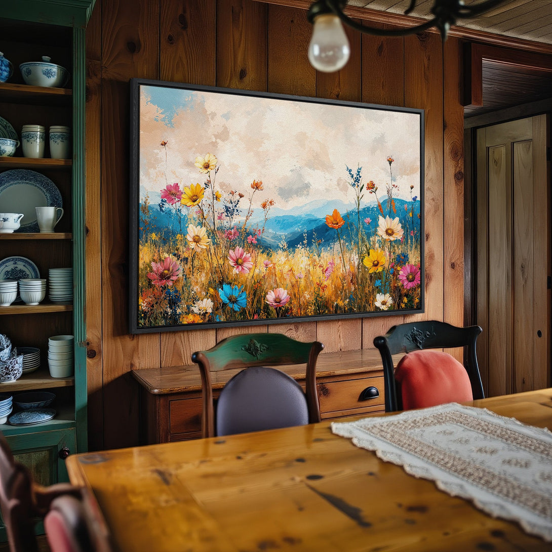 Framed Wall Art: Colorful wildflower meadow canvas print in a rustic interior. Featuring vibrant hues of blue, yellow, pink, and orange. Perfect for home decor!