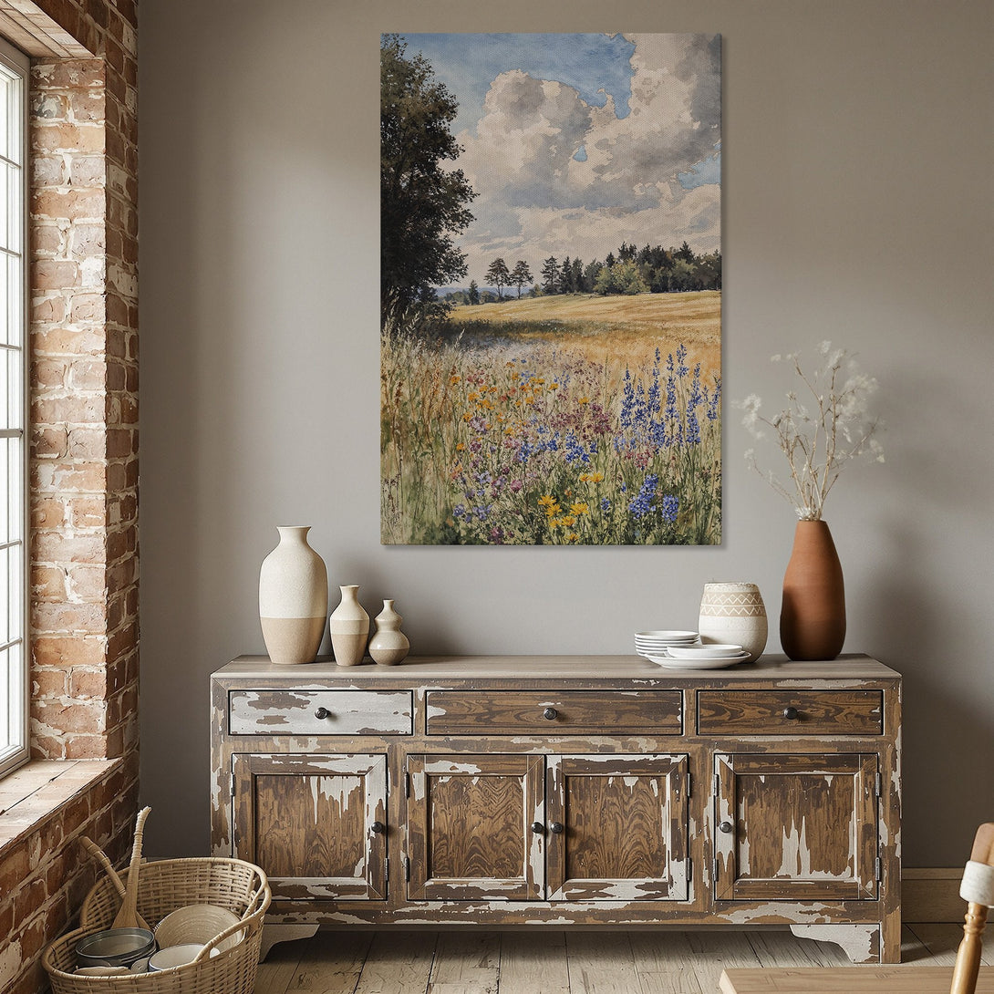 Framed Wall Art: Watercolor landscape Canvas Print with a field of wildflowers in a dining room. Earth tones and blue sky create a calming aesthetic.
