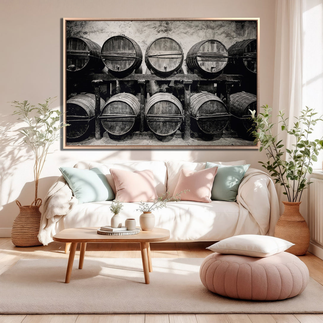 Framed Wall Art featuring a black and white image of wine barrels in a cellar. Adds a touch of rustic charm to any interior. Neutral color palette.