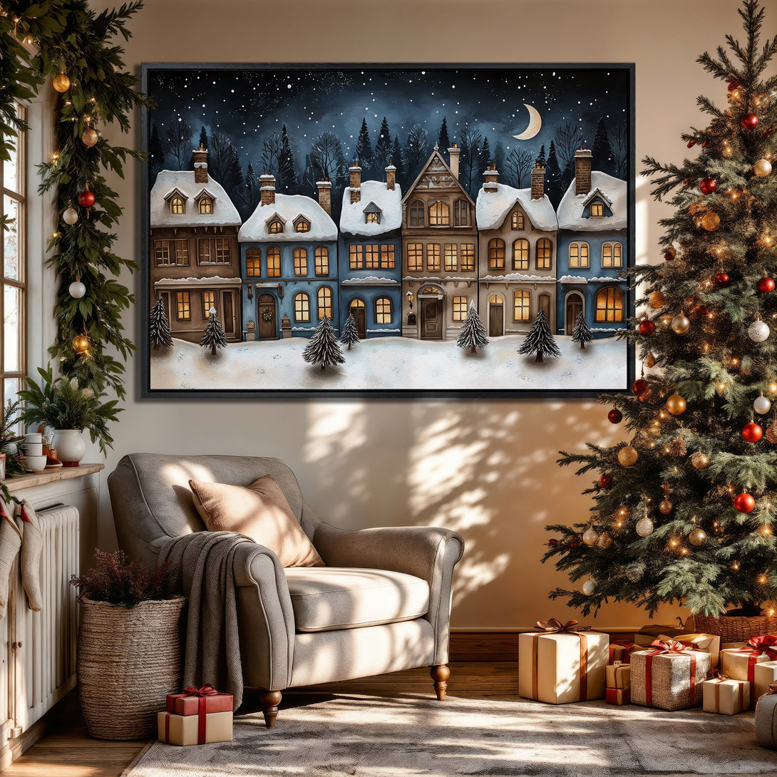 Framed Wall Art of a winter village scene in a cozy interior. Features a blue and brown color palette with a snowy night sky, perfect for holiday decor.