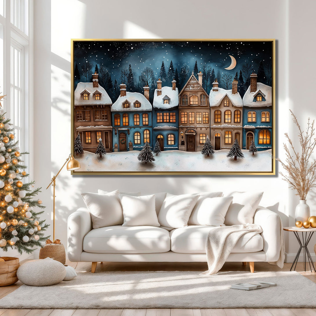 Canvas Print of a winter village scene in blue and brown tones, displayed in a cozy interior. Perfect for holiday decor!