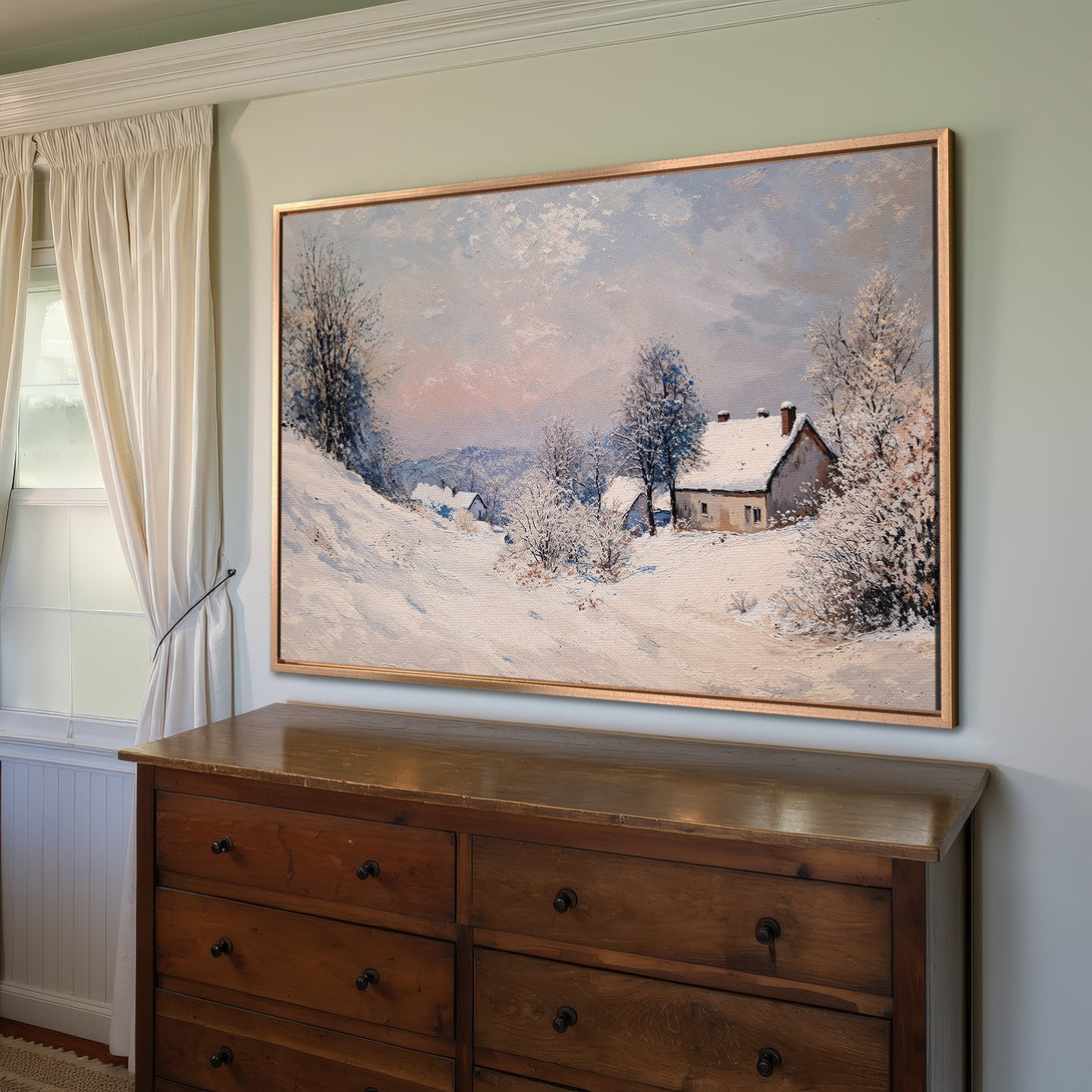 Framed Wall Art: Winter landscape painting in a classic style, featuring a snow-covered village with a soft blue, white, and pink color palette.