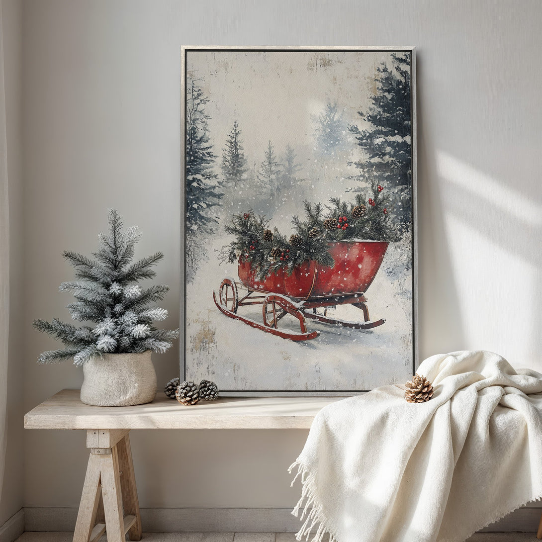 Framed Wall Art: Winter scene with a red sleigh, snowy forest, and neutral color palette. Rustic, cozy art for your home decor.