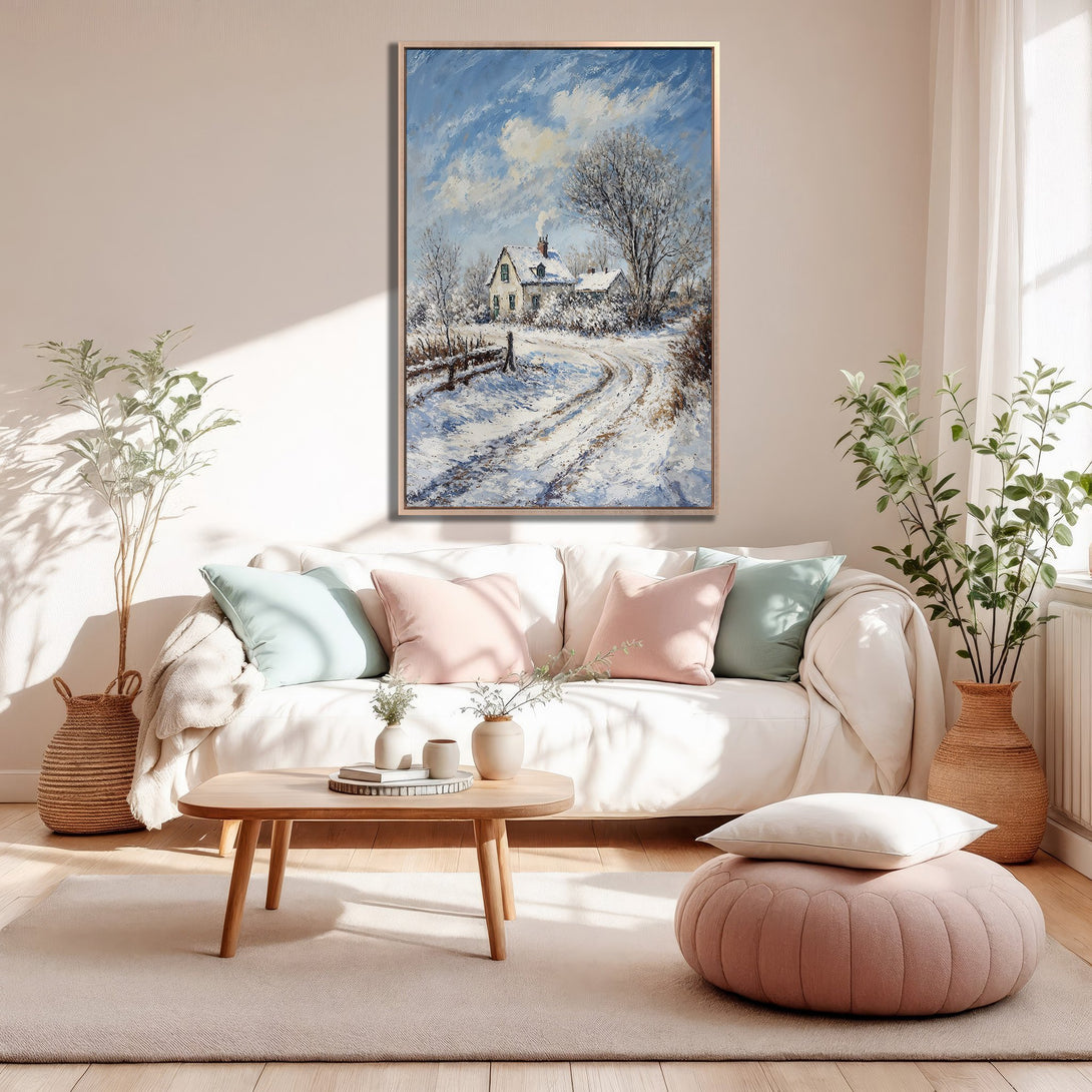 Framed Wall Art: Winter landscape canvas print in a cozy living room. Features a snowy scene with a house, in a blue, white, and brown color palette.
