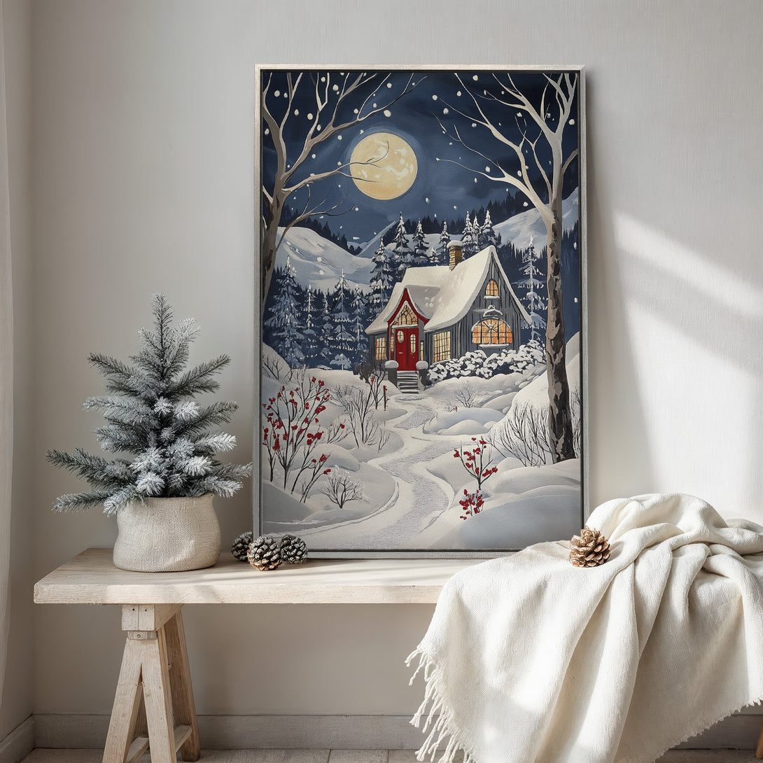 Framed Wall Art: Winter cabin scene in a snowy landscape. Cozy, whimsical style with a cool blue and white color palette. Perfect for holiday decor.