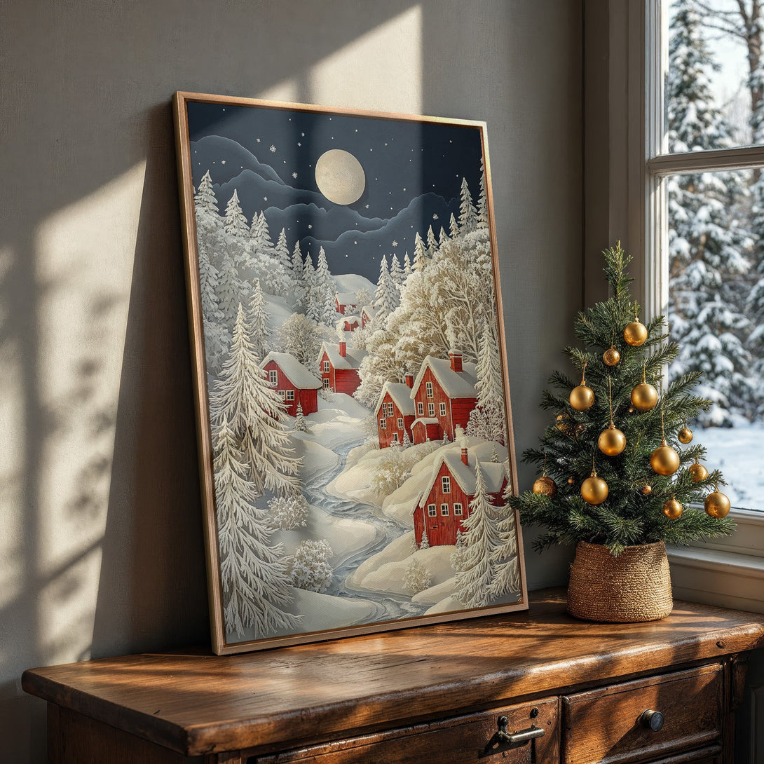 Framed Wall Art featuring a winter village scene with red houses, snow-covered trees, and a cool blue and white color palette. Perfect for cozy home decor!