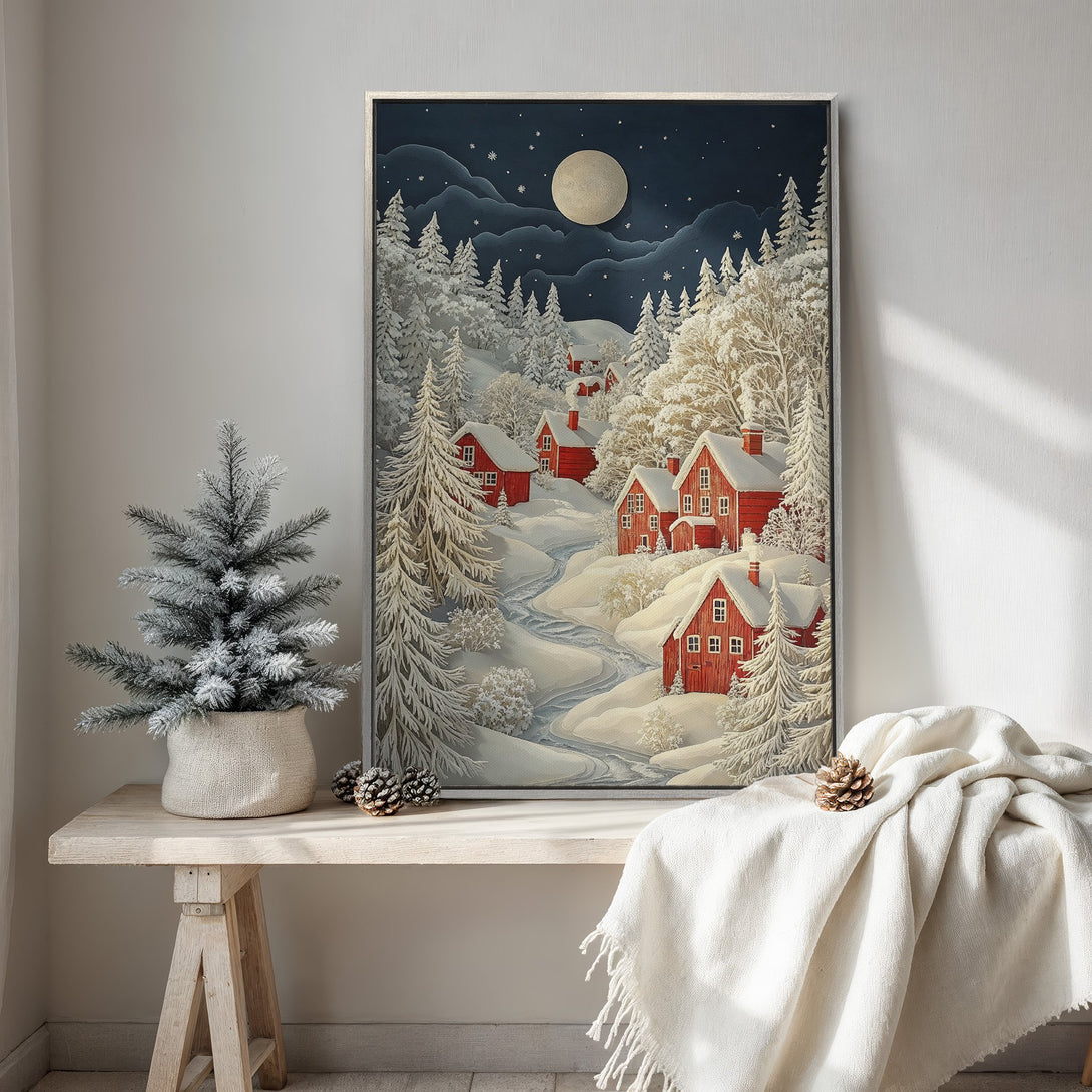 Framed Wall Art of a winter village scene with red houses, snowy landscape, and a night sky in a blue and white palette. Perfect for cozy decor.
