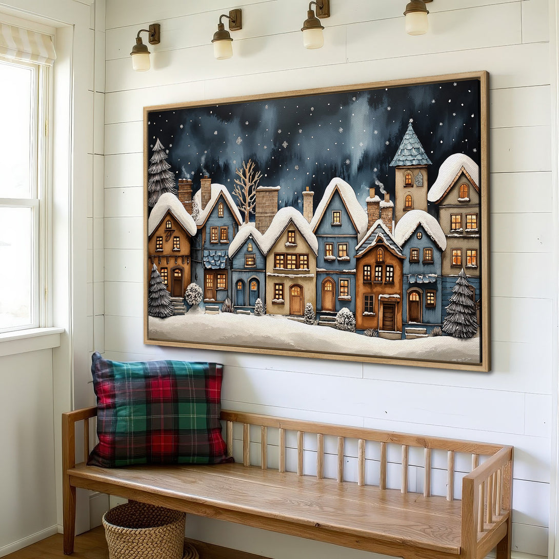 Framed Wall Art: Winter village scene in blue, brown, and white. Cozy cottagecore style canvas print for a warm, inviting interior.