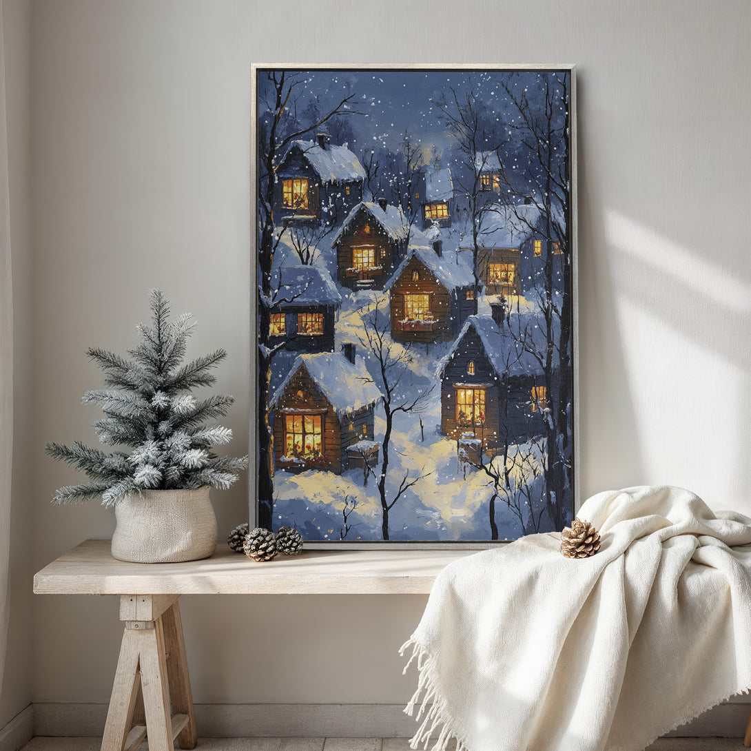 Framed Wall Art featuring a winter village scene in a cozy, painterly style. The cool blue and warm yellow palette creates a welcoming ambiance. Perfect for home decor.