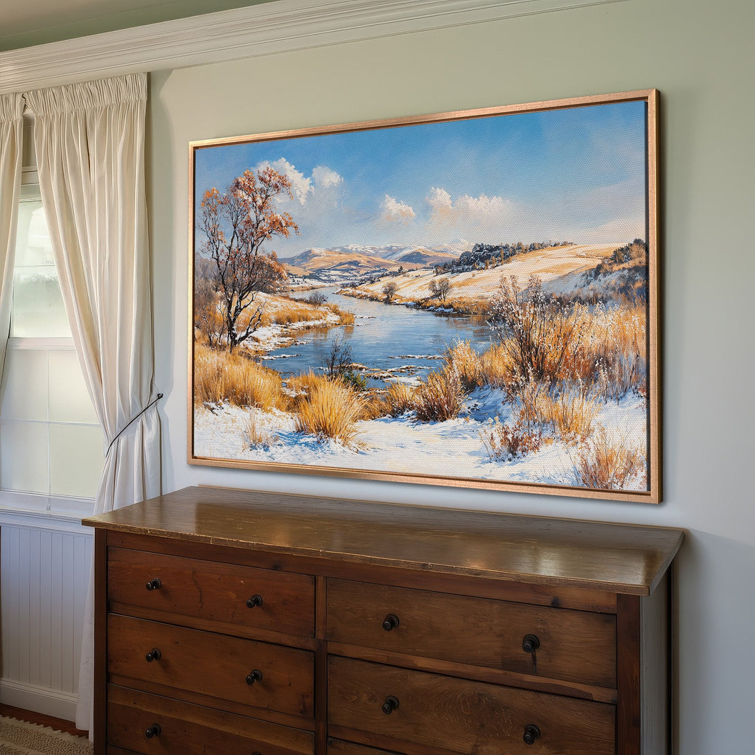 Framed Wall Art featuring a winter landscape painting with blue, white, and gold hues. Adds a touch of nature and elegance to any interior.