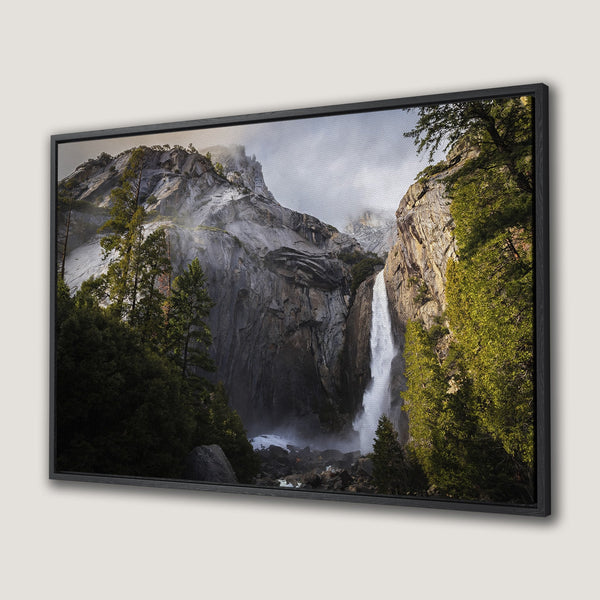 Framed Wall Art: Majestic waterfall canvas print featuring a stunning nature scene with lush greens, gray rock, and cascading water. Perfect for home decor.
