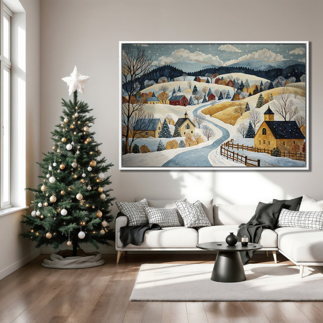 Framed Wall Art: Winter landscape Canvas Print in a cozy living room. Features a snowy village scene with a blue, white, and gold color palette. Perfect holiday decor!