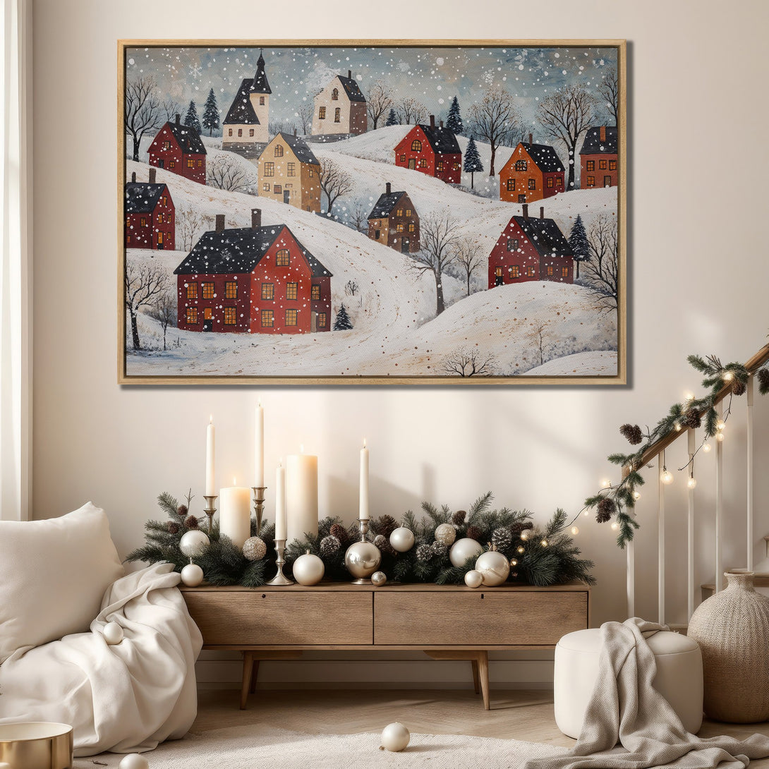 Framed Wall Art: Winter village scene in a folk art style. Red houses on snowy hills, framed in a warm wood tone. Cozy, inviting color palette for home decor.