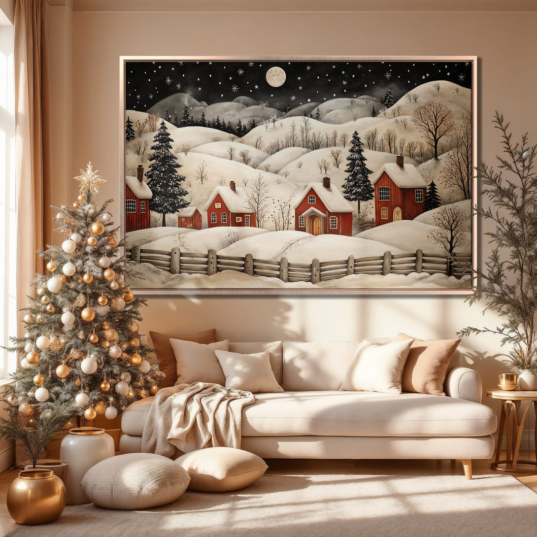 Framed Wall Art of a winter village scene in a cozy interior. Featuring a snowy landscape with red houses, black sky, and a warm, neutral color palette.