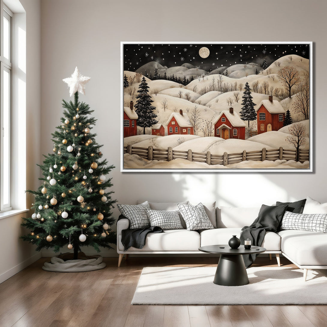 Framed Wall Art featuring a winter landscape with red houses, snowy hills, and a black night sky. Cozy, warm tones perfect for holiday decor.