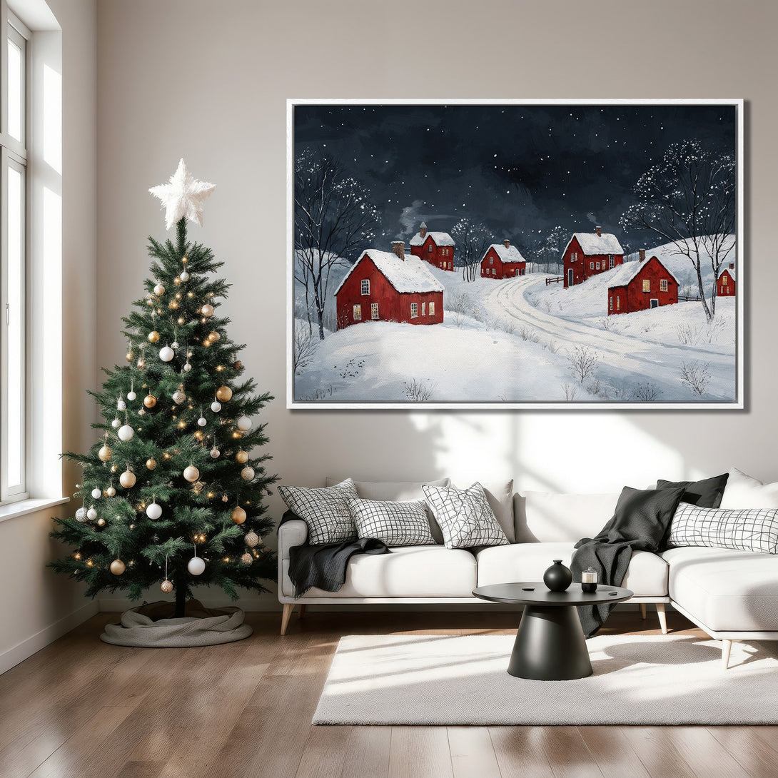 Framed Wall Art: Winter landscape Canvas Print with red houses & snowy scene in a cozy living room. Features a dark blue & white color palette, perfect for holiday decor.