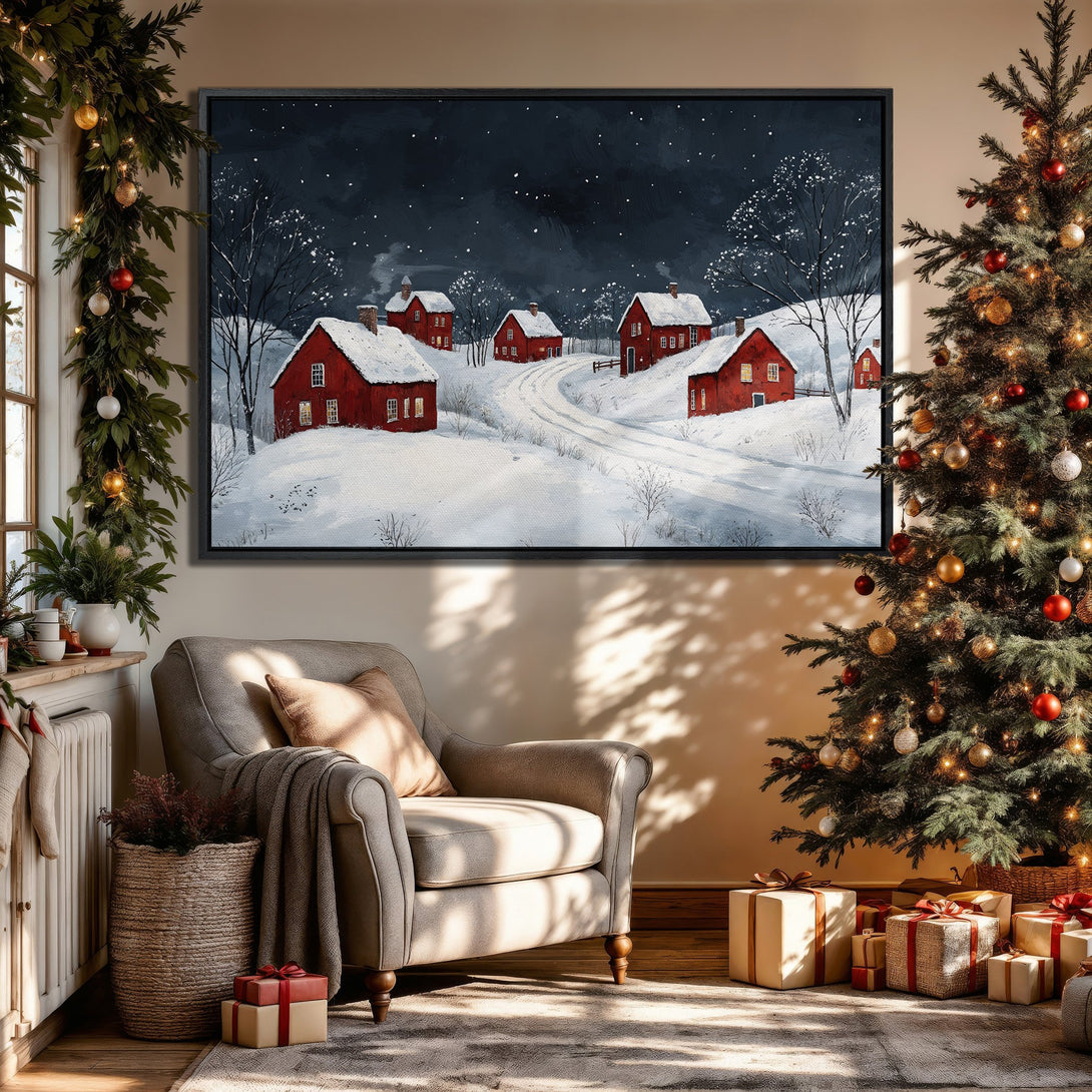 Framed Wall Art of a winter village scene with red houses, snowy landscape, and dark blue sky. Perfect holiday decor.
