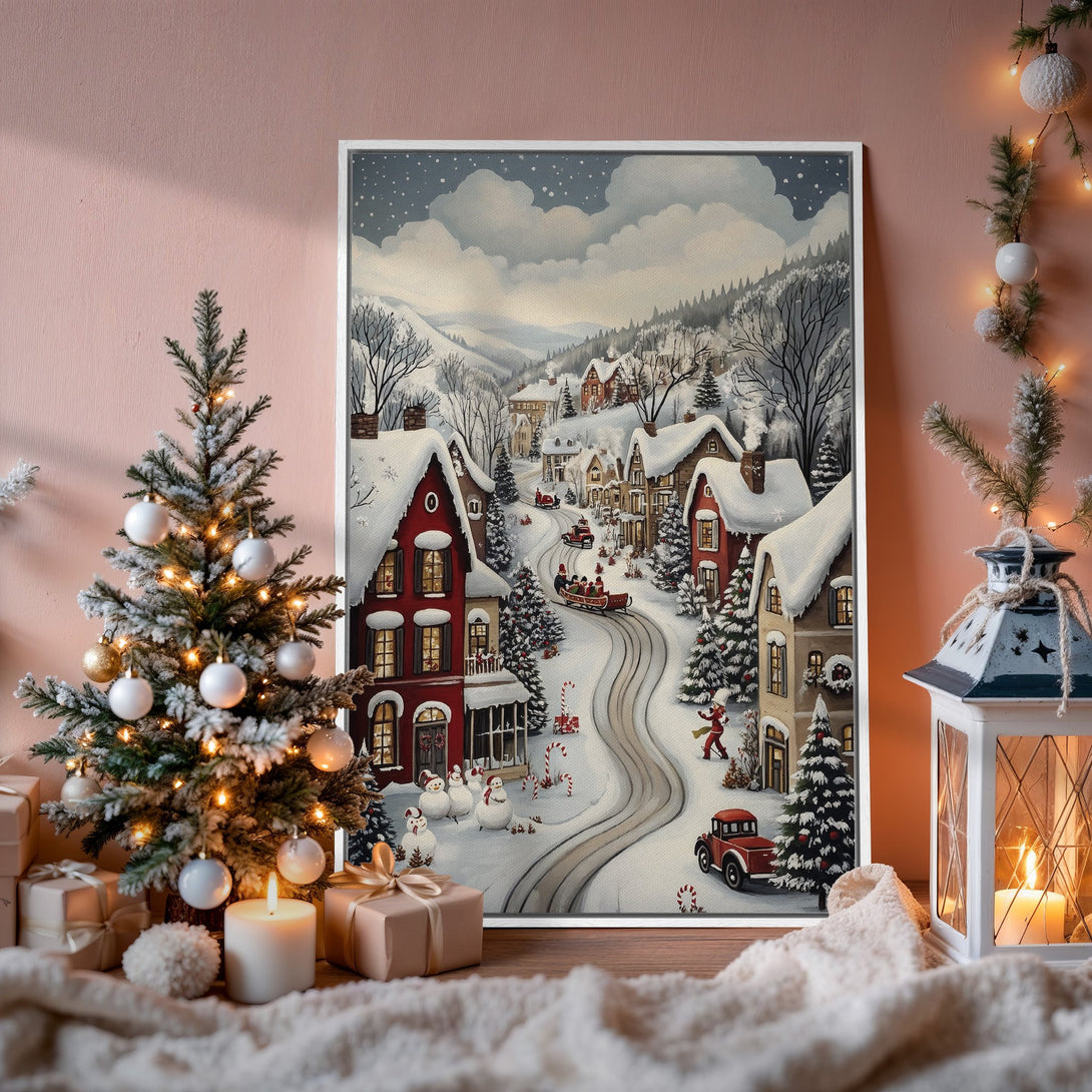 Framed Wall Art: Winter village scene Canvas Print in a cozy interior. Features a snowy landscape with red and neutral tones, perfect for holiday decor.