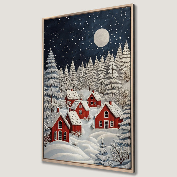 Framed Wall Art of a winter village scene with red houses, snow-covered trees, and a starry night sky. Cozy, textured art in a blue, white, and red palette.