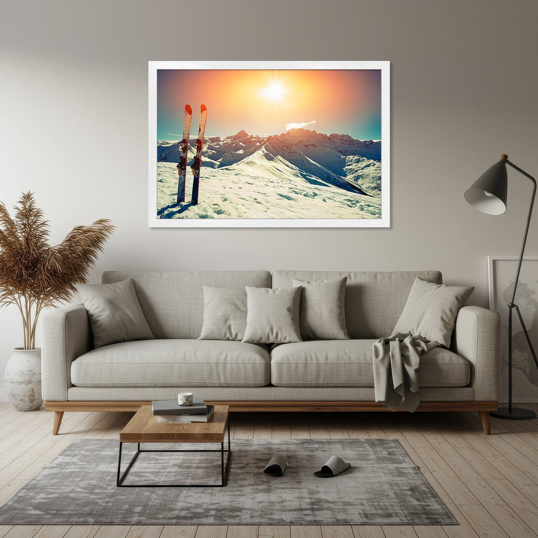 Framed Poster of snowy mountains with skis, vibrant sunset. Perfect for home decor, warm color palette.