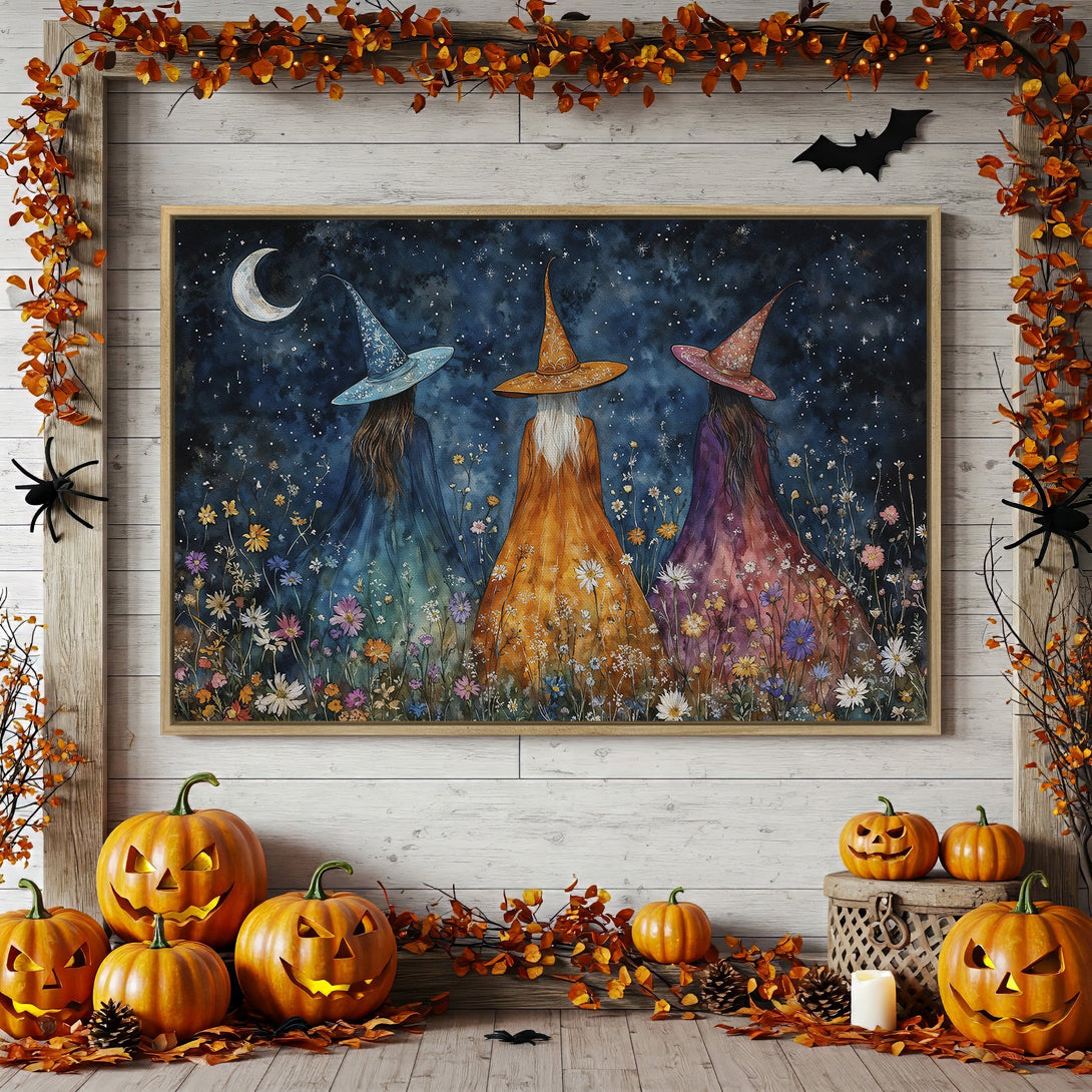 Framed Wall Art: Watercolor witch sisters in a starry night scene. Whimsical art with a blue, orange, and purple color palette, perfect for Halloween decor.