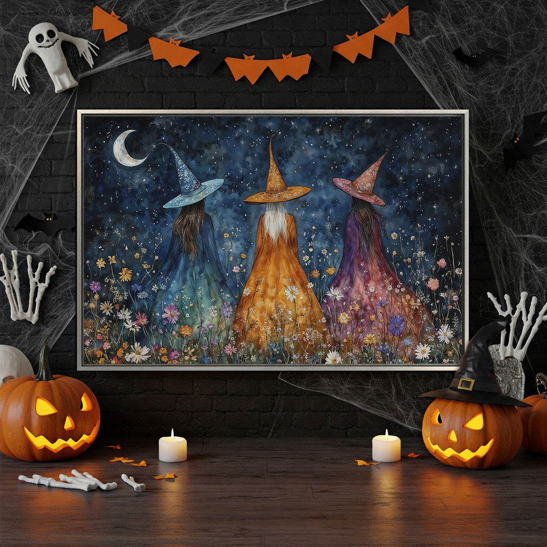 Framed Wall Art: Watercolor witches under a starry night sky. Whimsical art with a blue, orange, and purple color palette, perfect for Halloween decor.