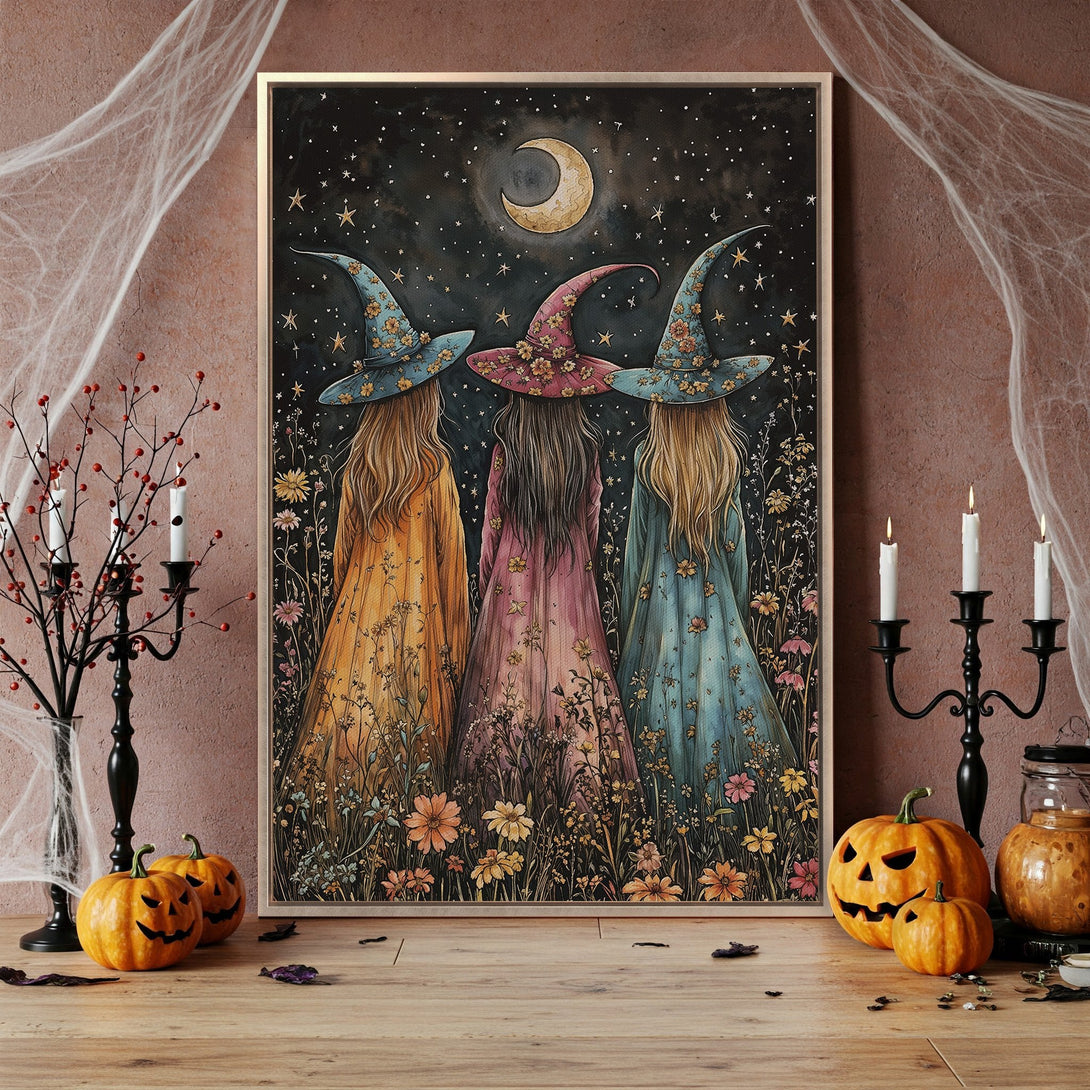 Framed Wall Art featuring three witches in whimsical style, with a dark night sky and floral details. Warm, autumnal color palette. Perfect Halloween decor.