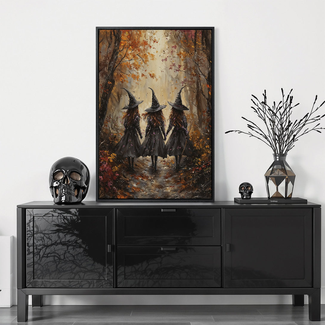 Framed Wall Art featuring three witches in an autumn forest. Moody, impressionistic style with a warm, autumnal color palette. Perfect Halloween decor!