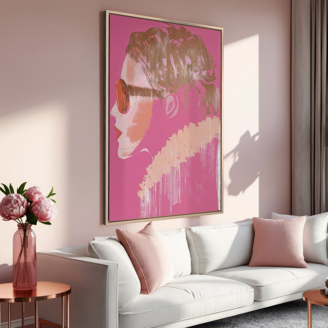 Framed Wall Art: Abstract portrait in pink and gold tones. Modern canvas print adds a pop of color to a stylish living room.