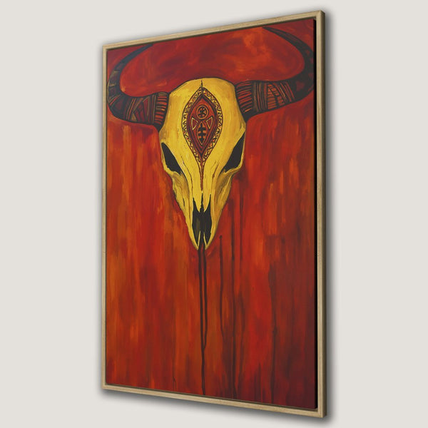 Framed Wall Art: Bold bull skull canvas print in warm red & gold tones. Add a touch of Southwestern style to your home decor!