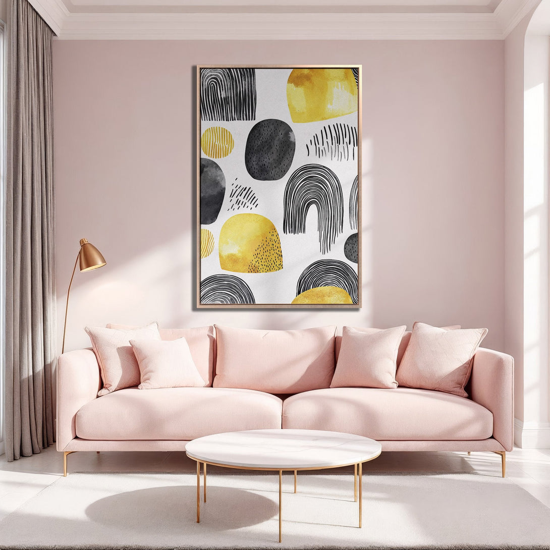 Framed Wall Art featuring abstract shapes in black, yellow, and gray. Modern art canvas print adds a pop of color to a stylish living room interior.