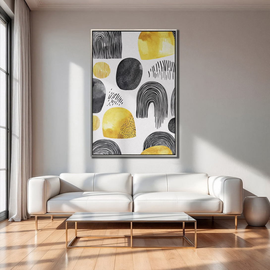 Framed Wall Art featuring abstract shapes in yellow, black, and gray. Modern art print adds a pop of color to any living room.