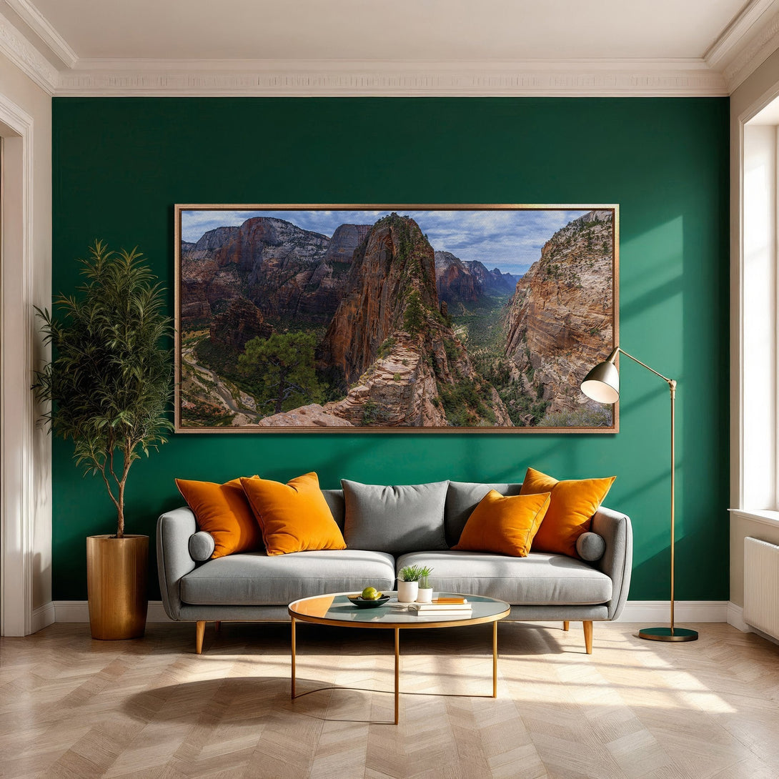 Framed Wall Art of a majestic mountain landscape in warm earth tones, displayed in a modern interior with a deep green wall and orange accents.