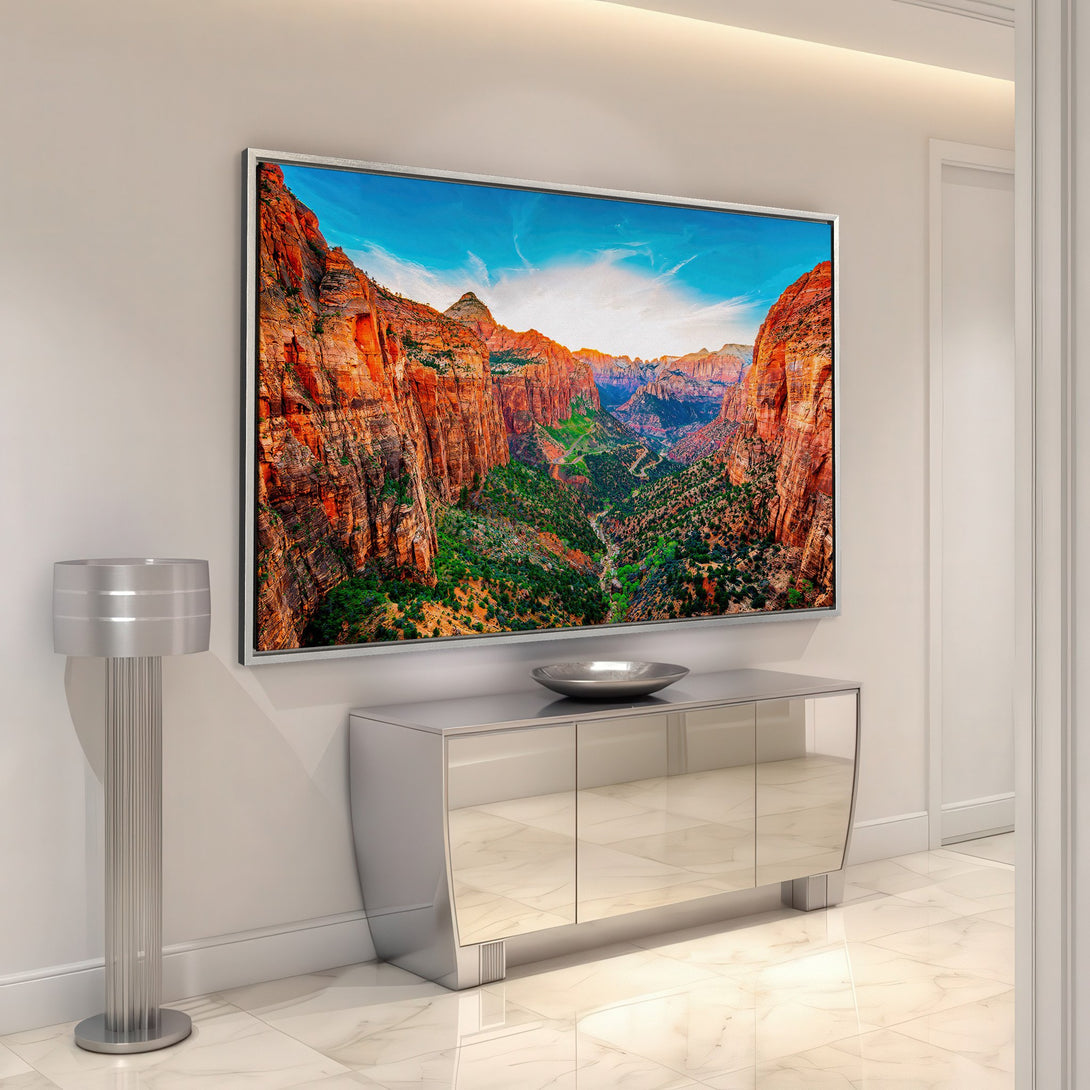 Framed Wall Art featuring a vibrant canyon landscape. Earthy tones of red, orange, and green pop against a blue sky. Elevate your space with this stunning artwork.