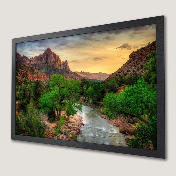 Framed Poster of Zion National Park landscape. Warm sunset hues with green foliage and red rock formations. Perfect wall art.
